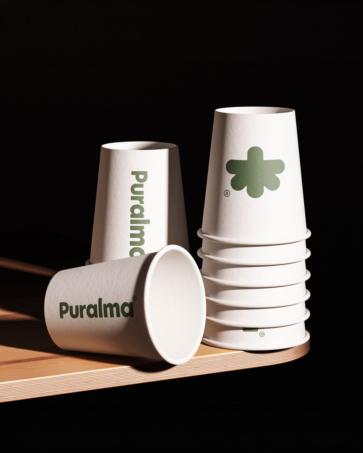 Puralma. Branded paper cups stacked on a counter.