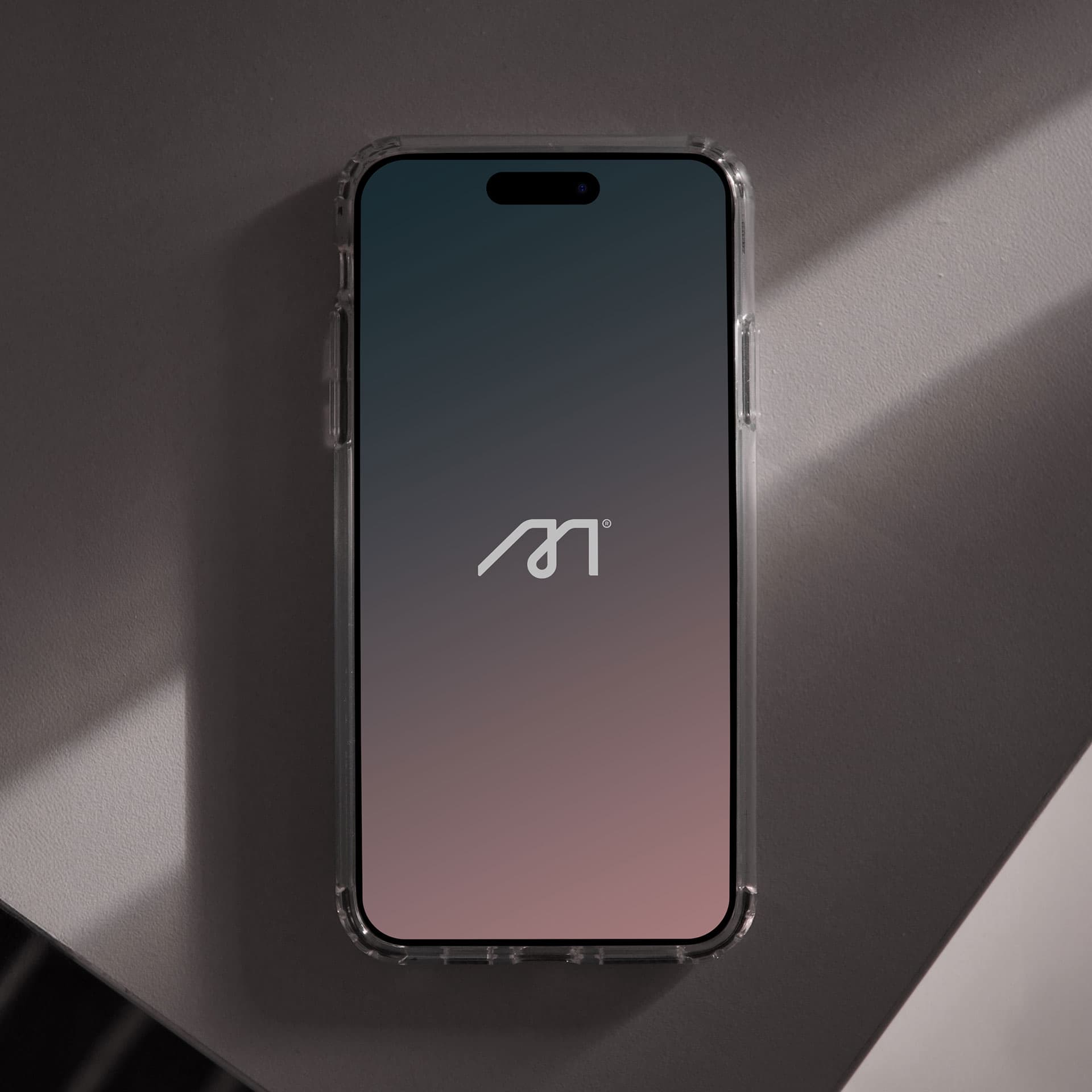 Susana Méndez. The M wordmark on a phone lock screen.